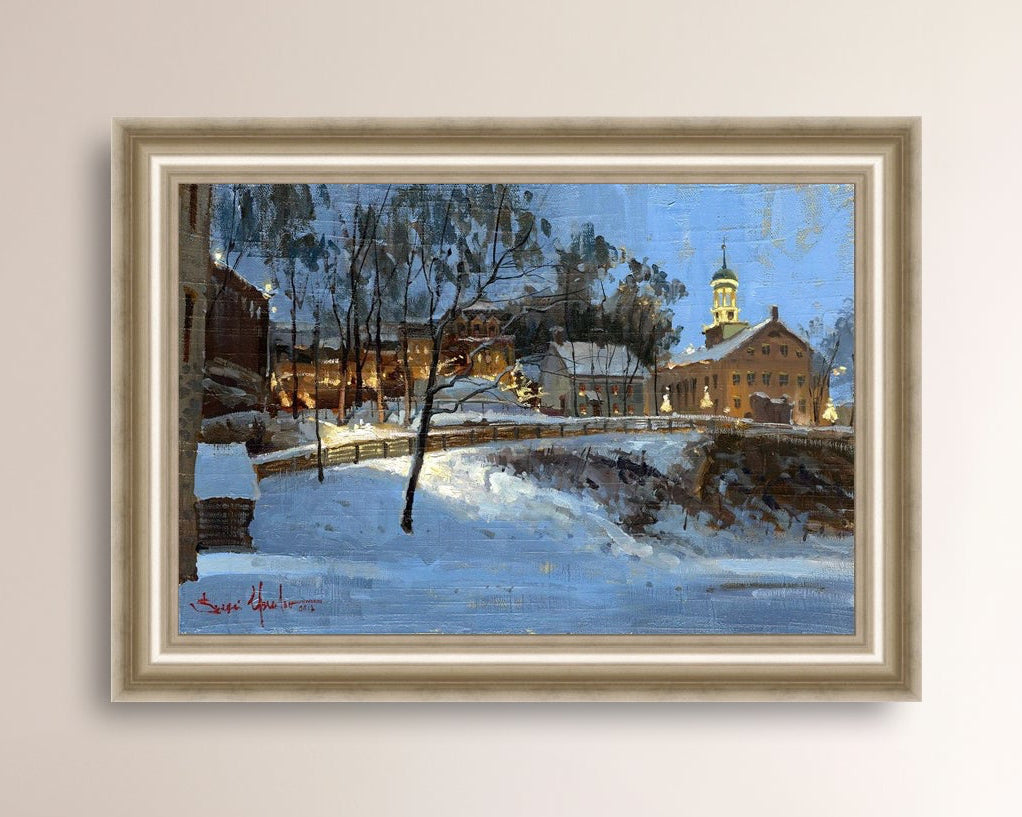 Winter scene with Moravian Church and Main Street, illuminated by lights.