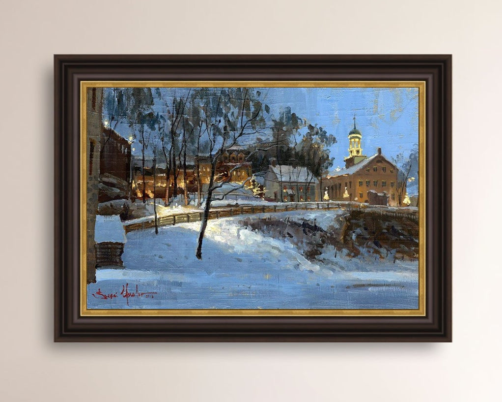 Winter scene with Moravian Church and Main Street, illuminated by lights.