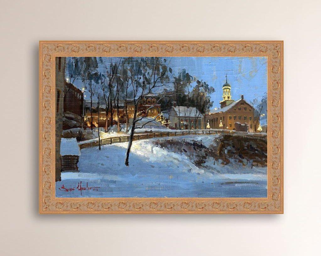 Winter scene with Moravian Church and Main Street, illuminated by lights.