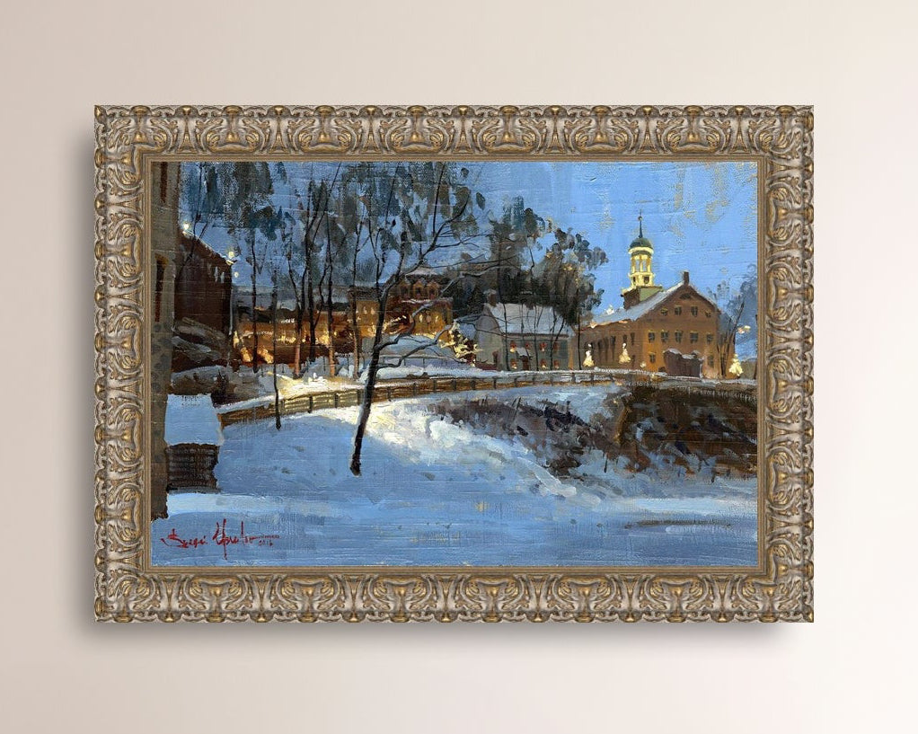 Winter scene with Moravian Church and Main Street, illuminated by lights.
