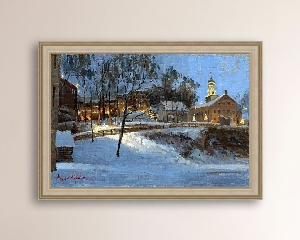 Winter scene with Moravian Church and Main Street, illuminated by lights.