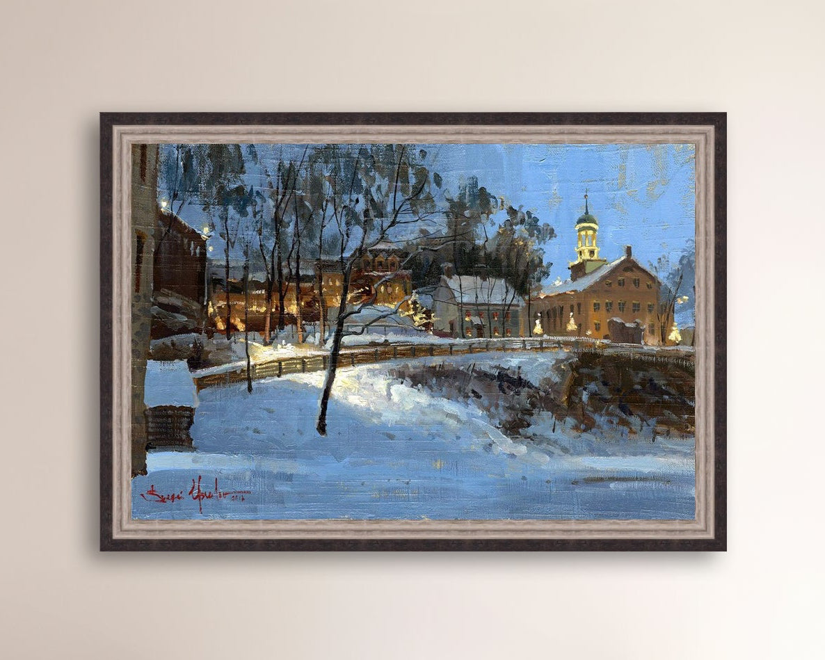 Winter scene with Moravian Church and Main Street, illuminated by lights.