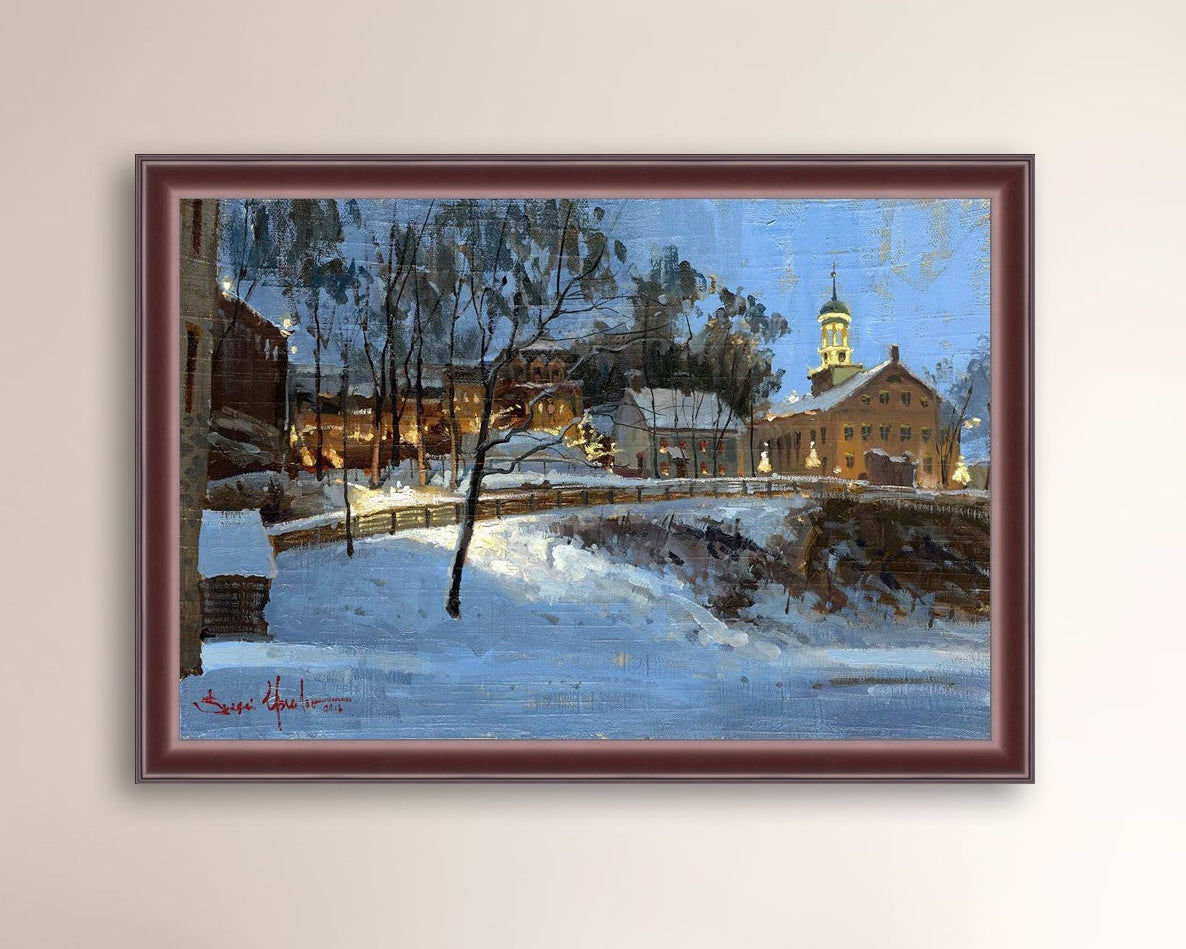 Winter scene with Moravian Church and Main Street, illuminated by lights.