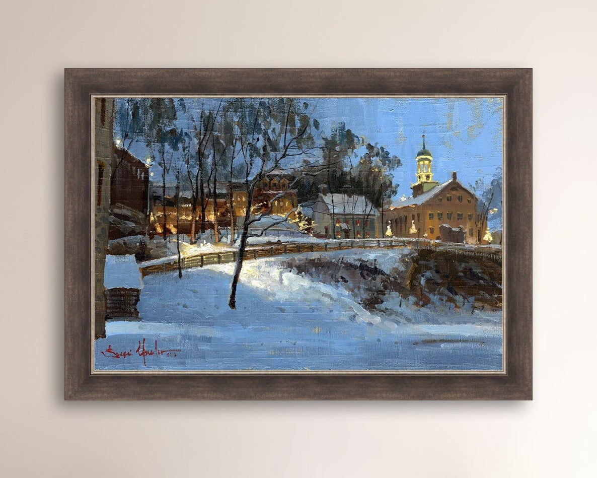 Winter scene with Moravian Church and Main Street, illuminated by lights.