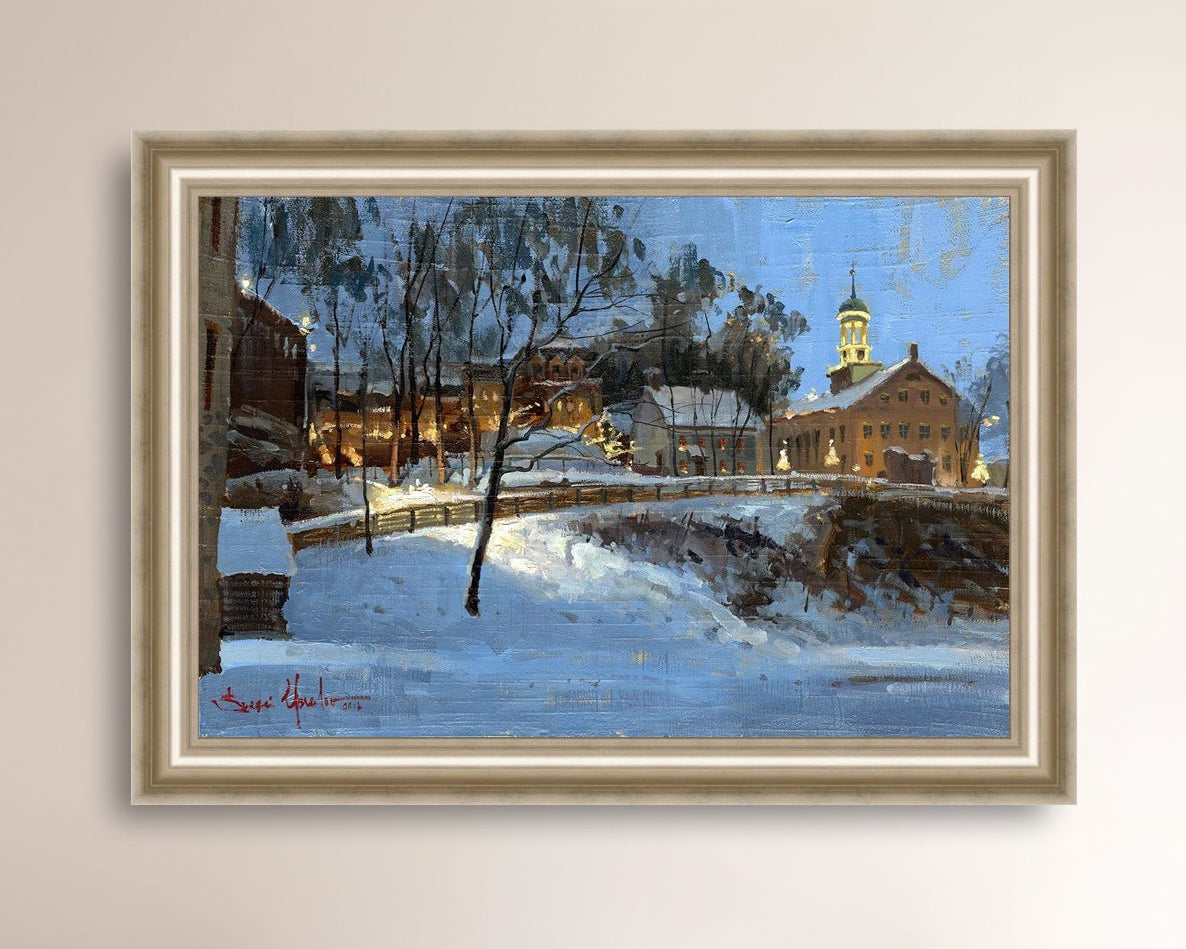 Winter scene with Moravian Church and Main Street, illuminated by lights.
