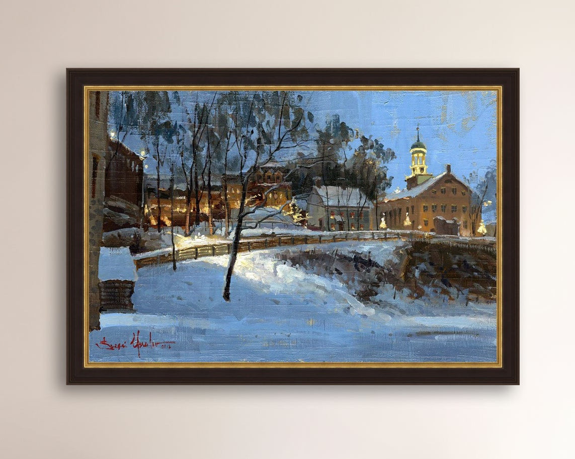 Winter scene with Moravian Church and Main Street, illuminated by lights.