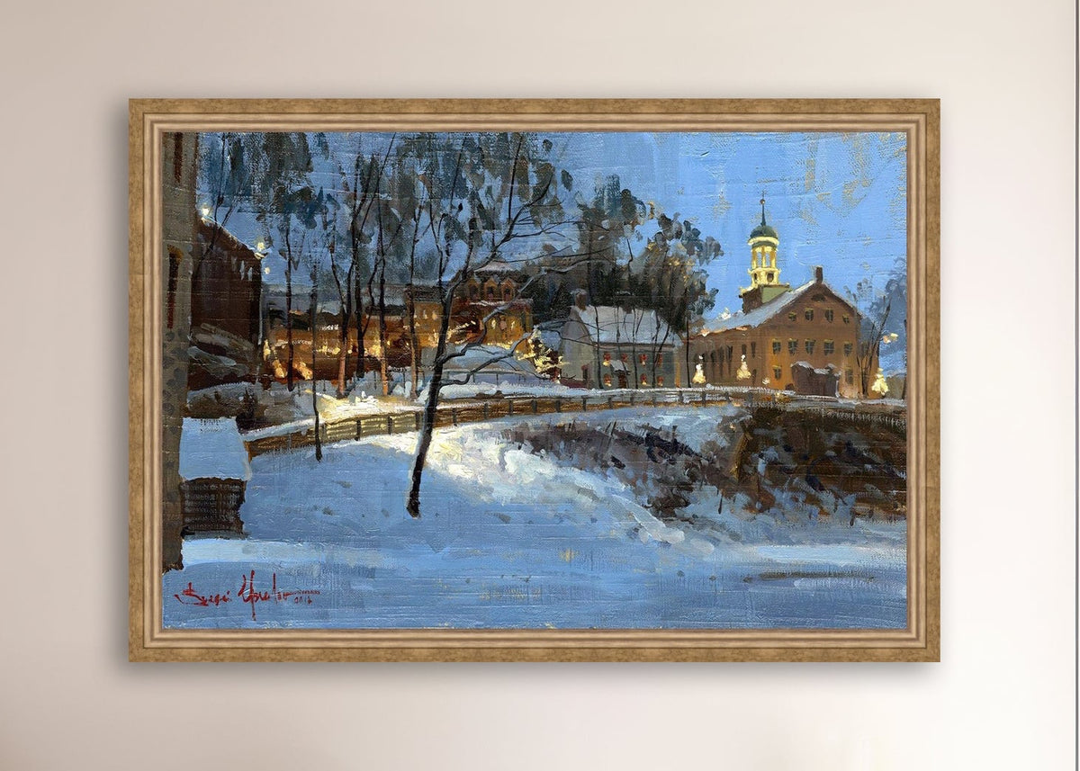 Winter scene with Moravian Church and Main Street, illuminated by lights.