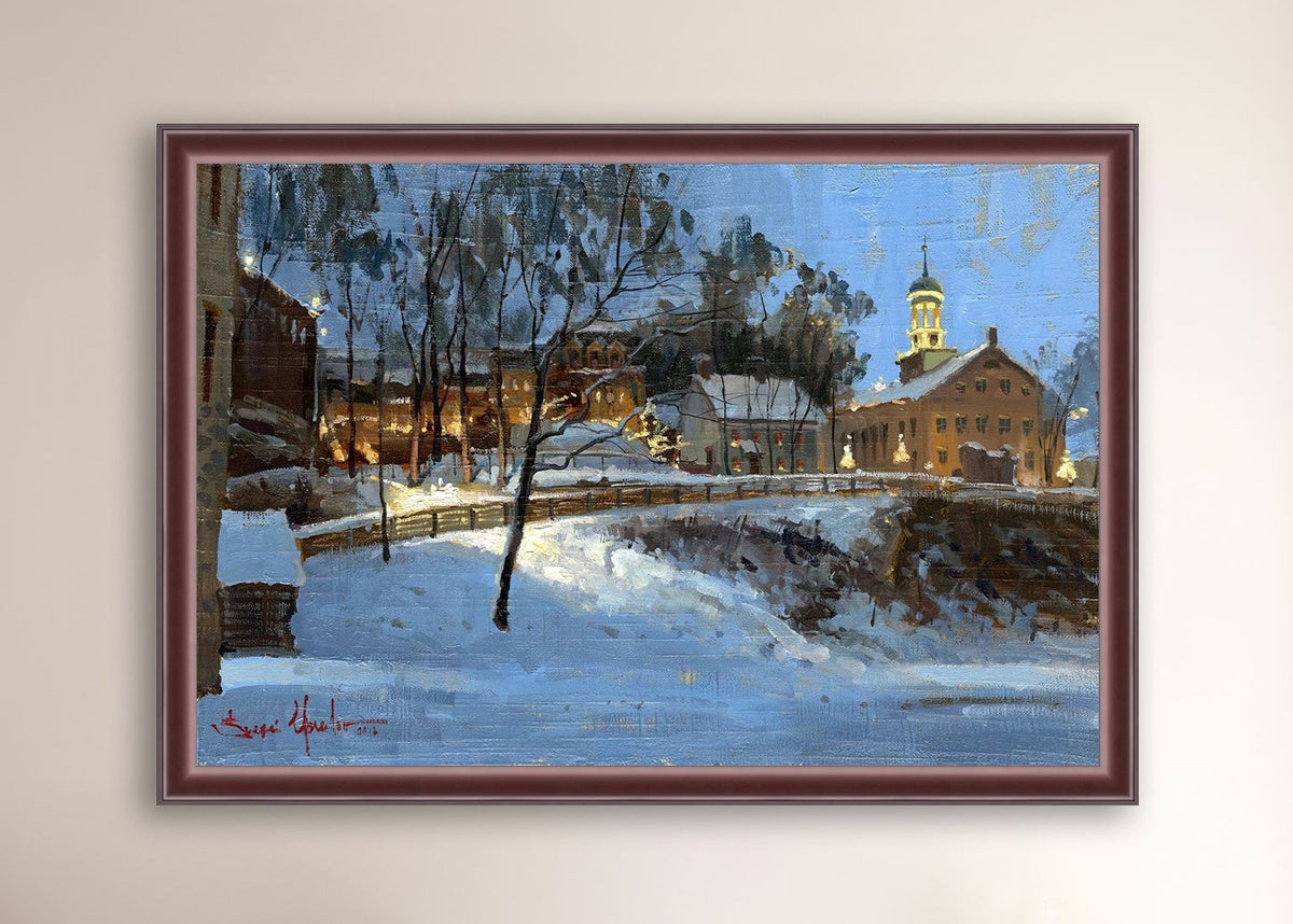 Winter scene with Moravian Church and Main Street, illuminated by lights.
