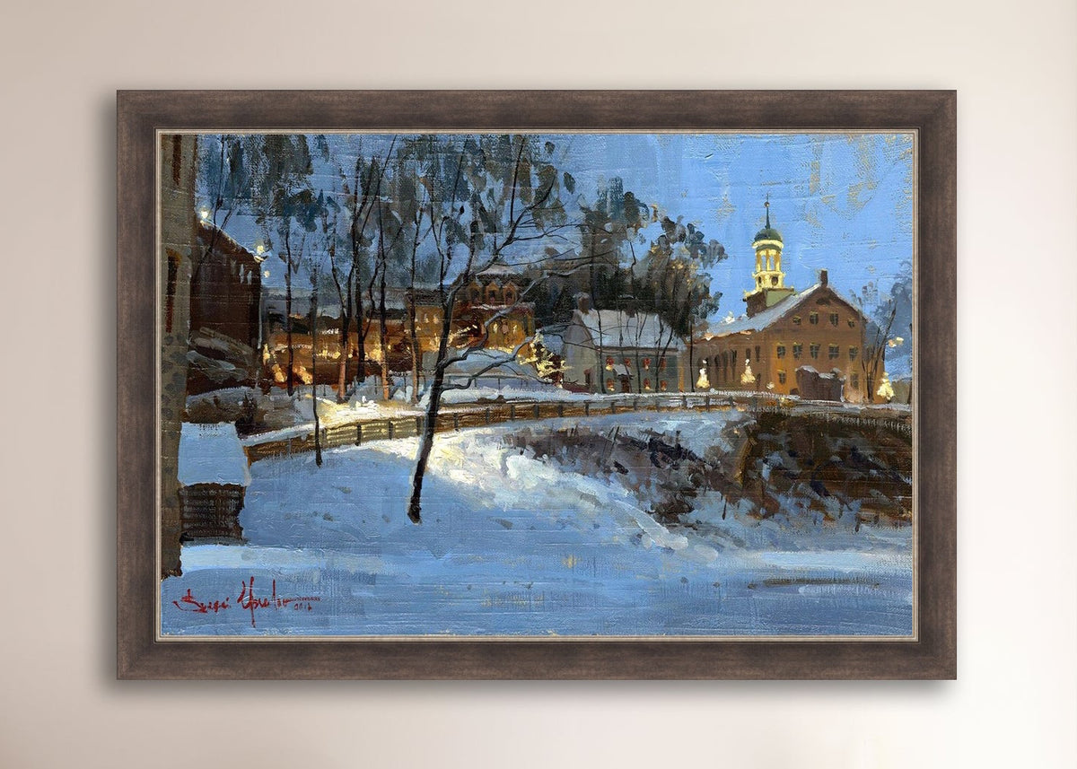 Winter scene with Moravian Church and Main Street, illuminated by lights.