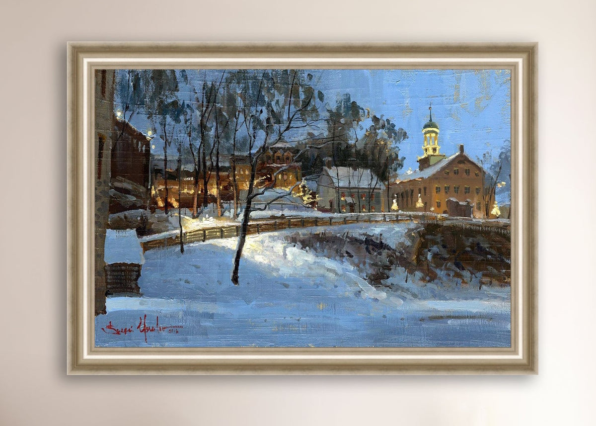 Winter scene with Moravian Church and Main Street, illuminated by lights.