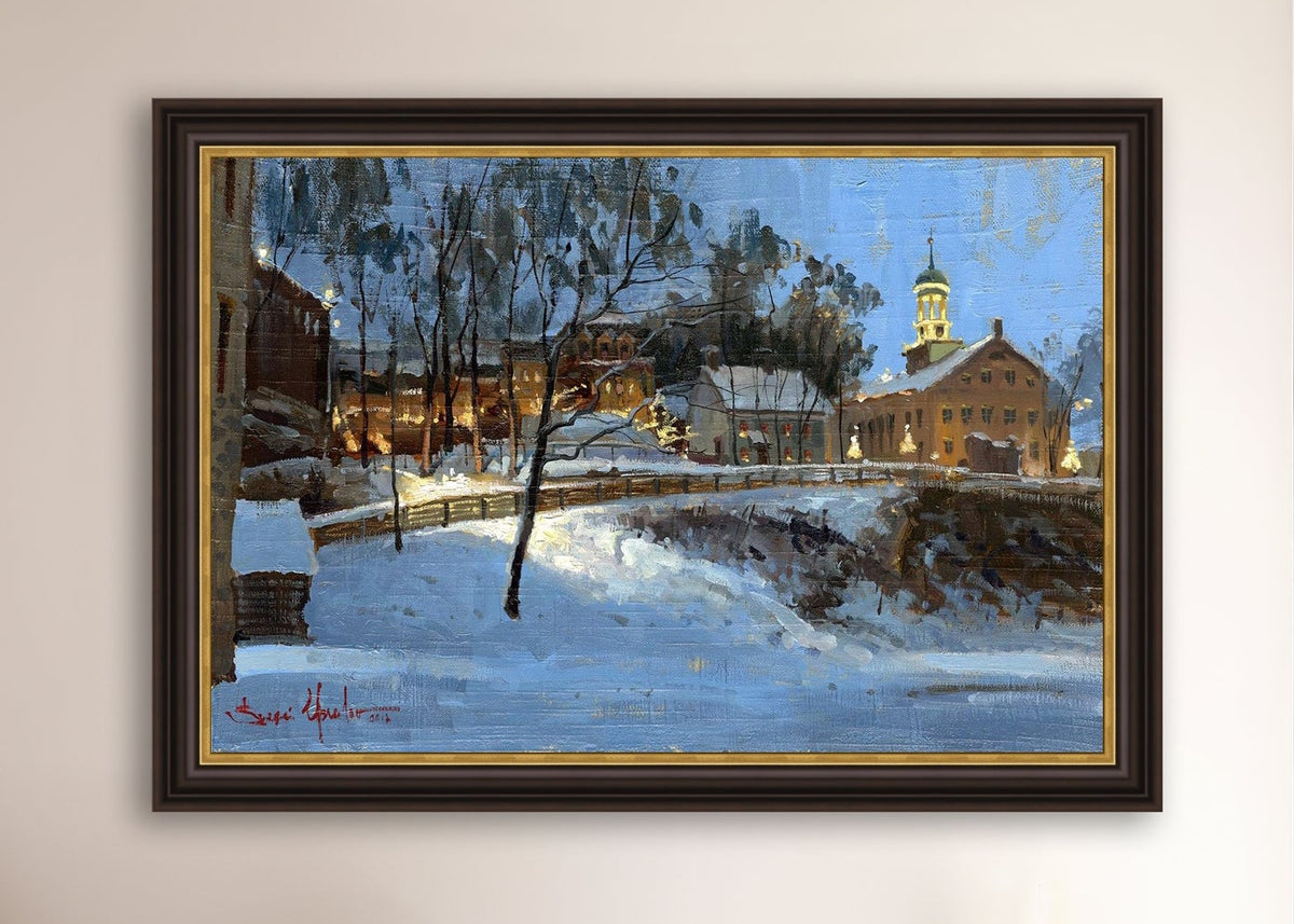 Winter scene with Moravian Church and Main Street, illuminated by lights.