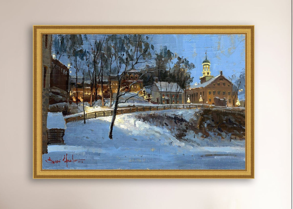 Winter scene with Moravian Church and Main Street, illuminated by lights.