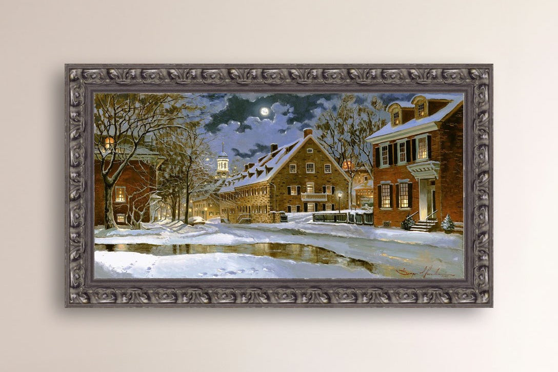 Snowy Bethlehem scene with Moravian Church at night.