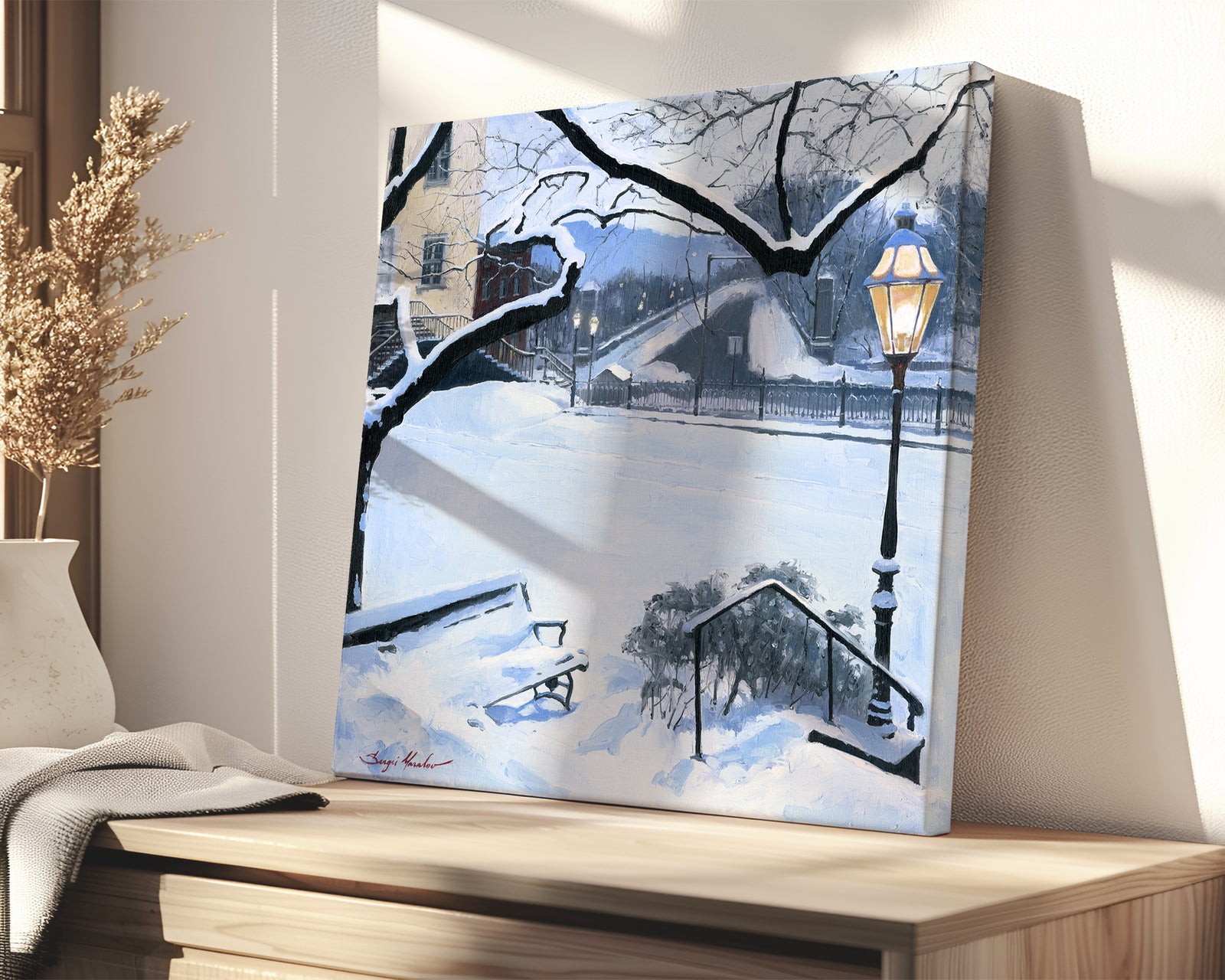 A canvas print featuring a snowy landscape with a bench, a lamp post, in the foreground, and Moravian Church in the background.